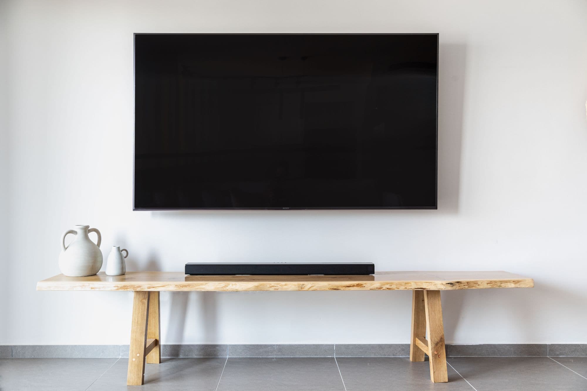Wall-mounted flat screen television in a minimalist living room