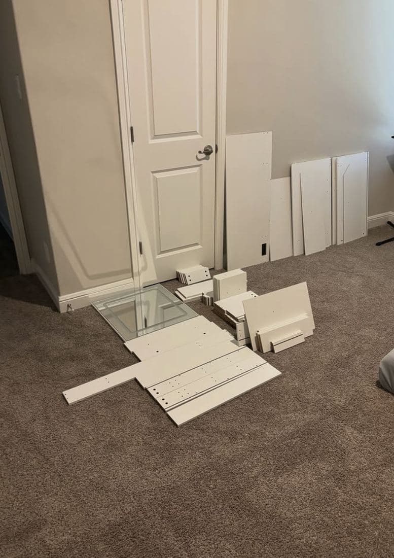 Furniture broken down into flat panels stacked neatly beside a doorway