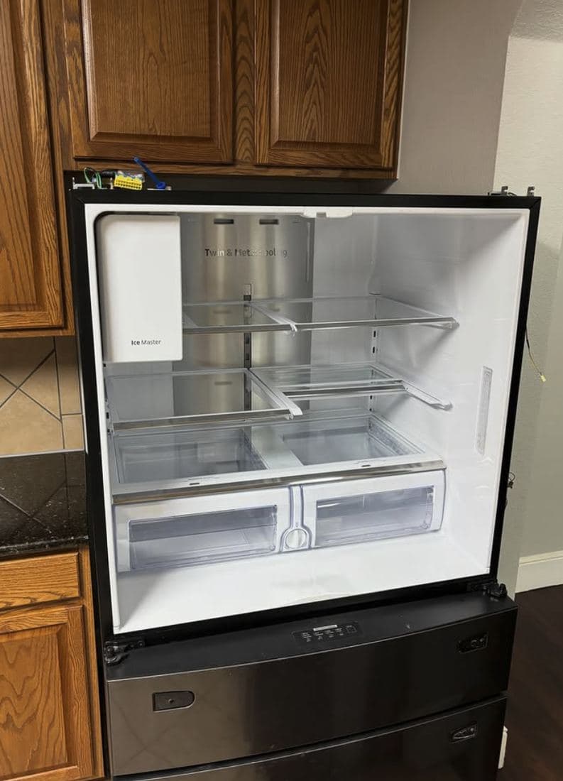 Refrigerator with doors open showing a newly connected ice maker water line