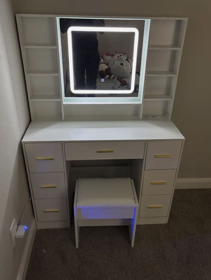 White makeup vanity with an illuminated LED mirror and matching bench